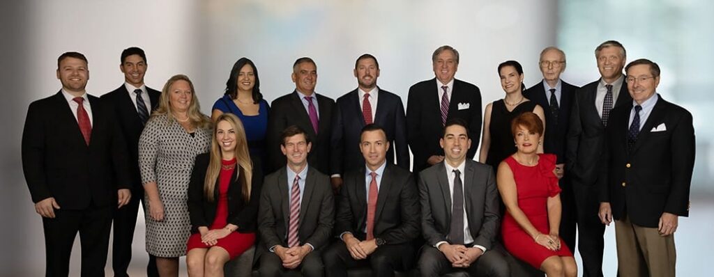 Company group portrait of a large team in business attire