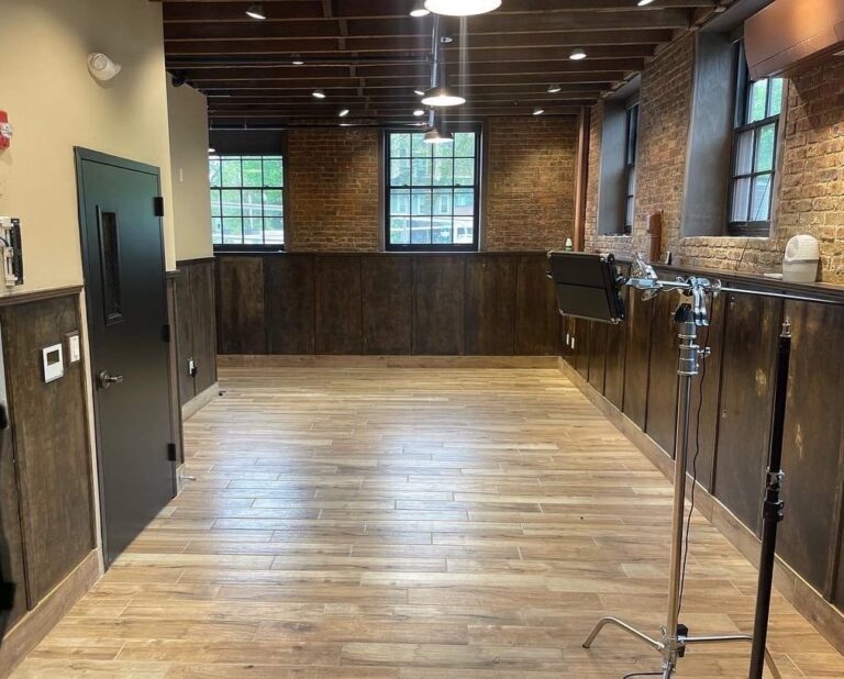 The Five Star SEO photography studio in Freehold, NJ, with brick walls, wood paneling and lighting stands