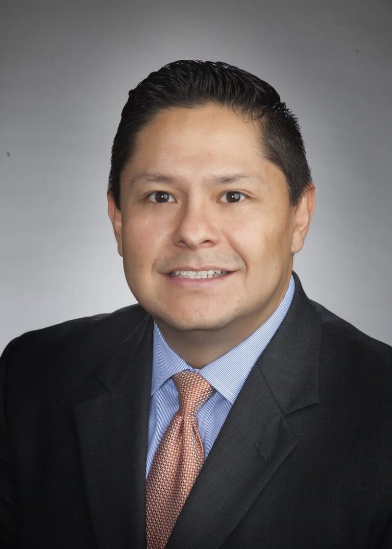 Team headshot on a gray backdrop from a matched company set