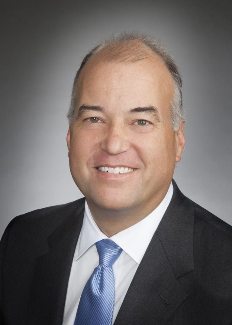 Team headshot on a gray backdrop from a matched company set